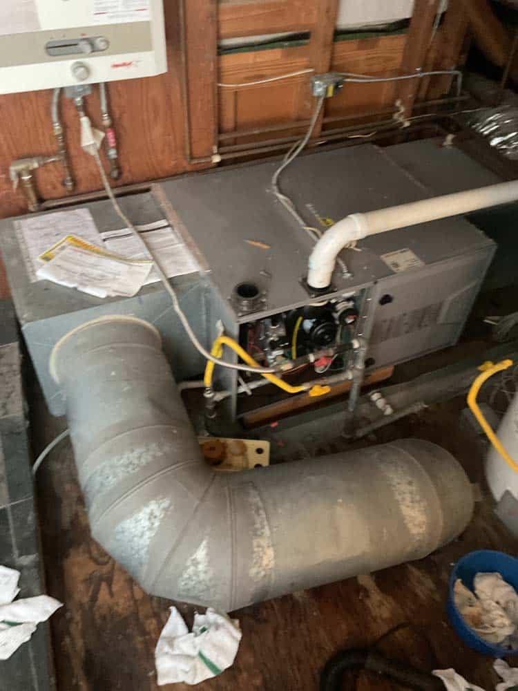 technician inspecting heating equipment in a Bay Area home technician inspecting heating equipment in a Bay Area home